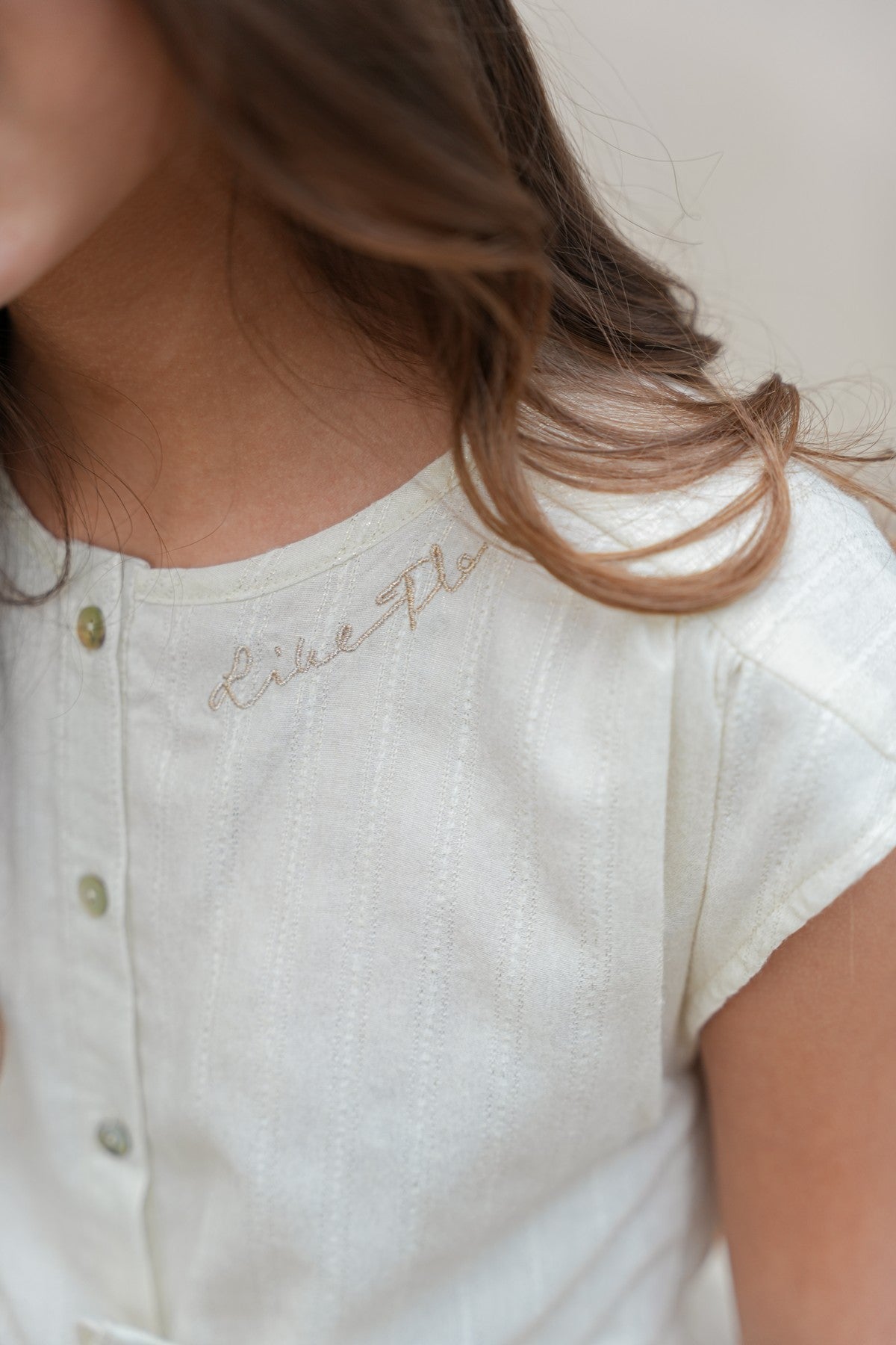 Maika Flo girls glitter dress with knot and button closure at front